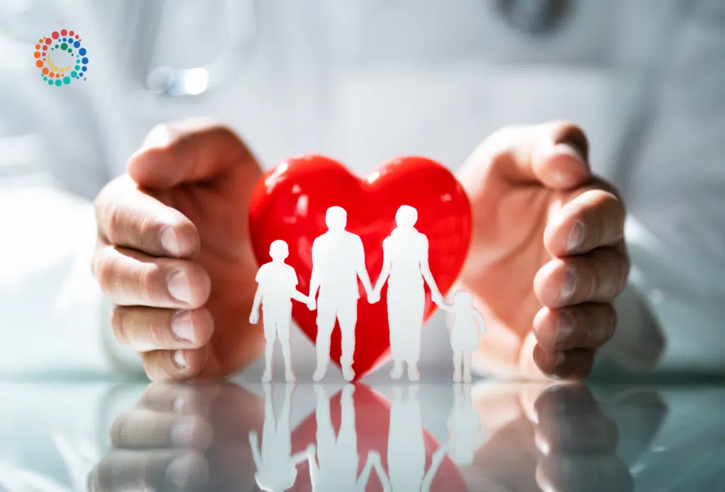 Hands holing a red heart with white cutouts of people